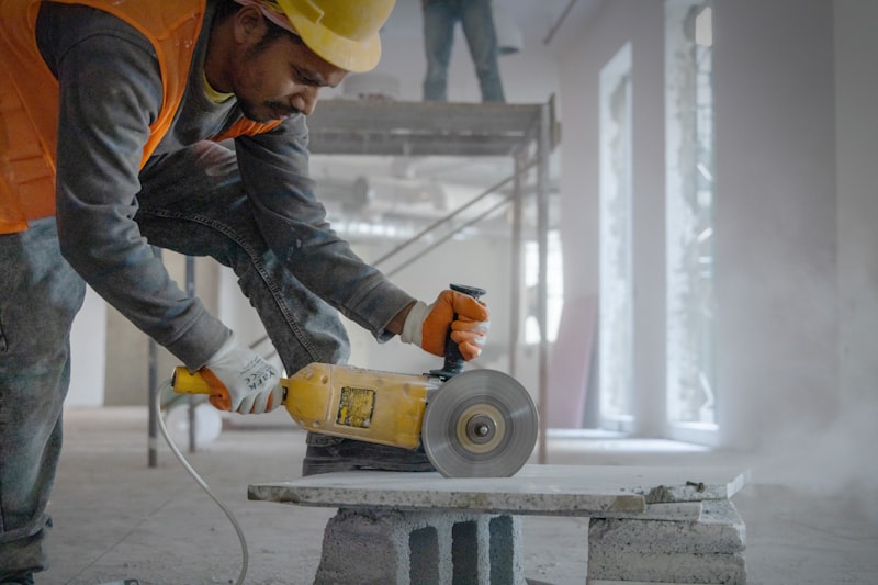 Operative using an angle grinder with PPE